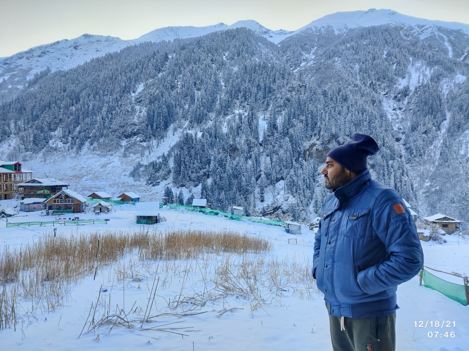 Deepak standing in a snowy mountain valley